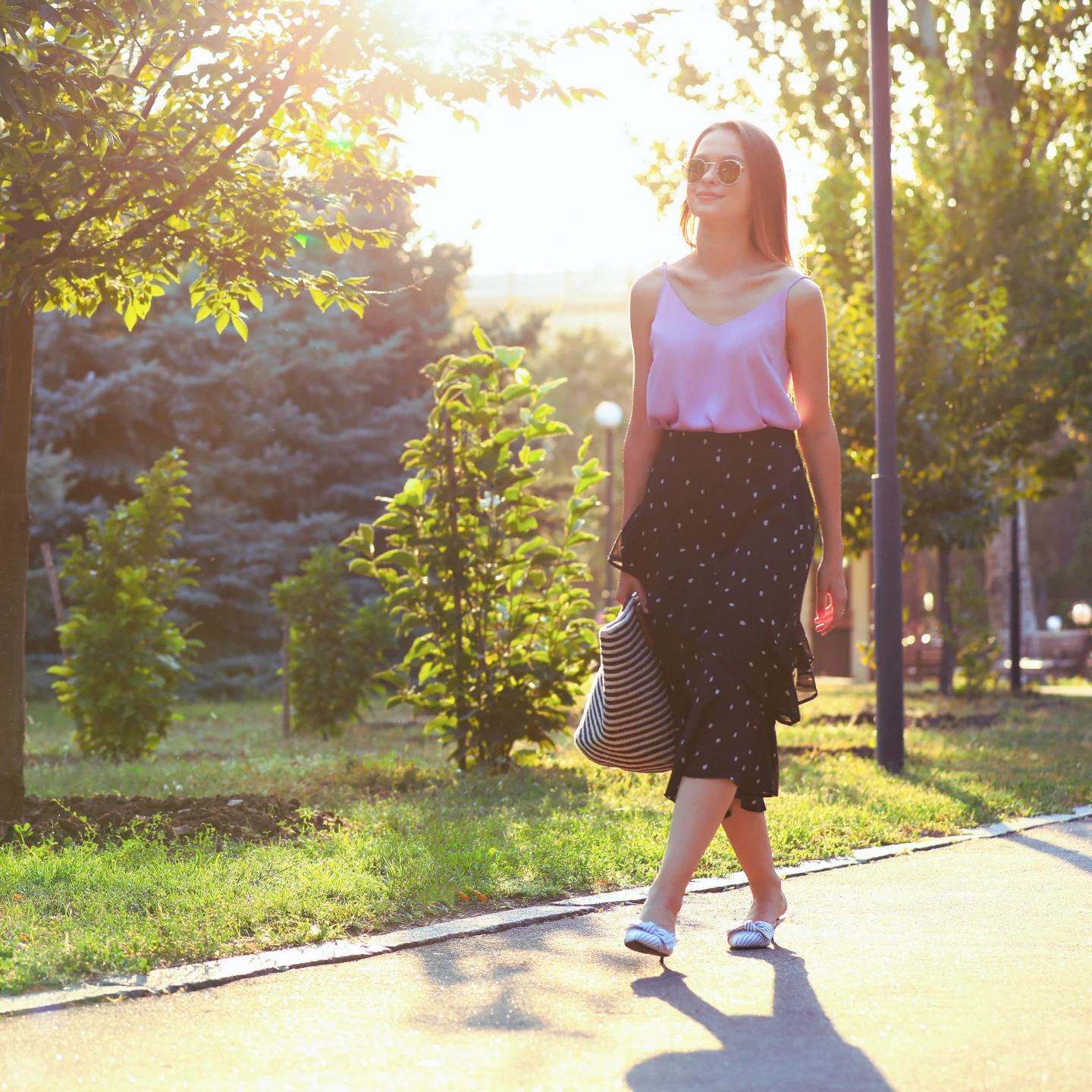 Woman walking peacefully through a park, experiencing freedom and relief from OCD and anxiety through ERP therapy with Celine Bongaert with Wellness Counseling, PLLC.