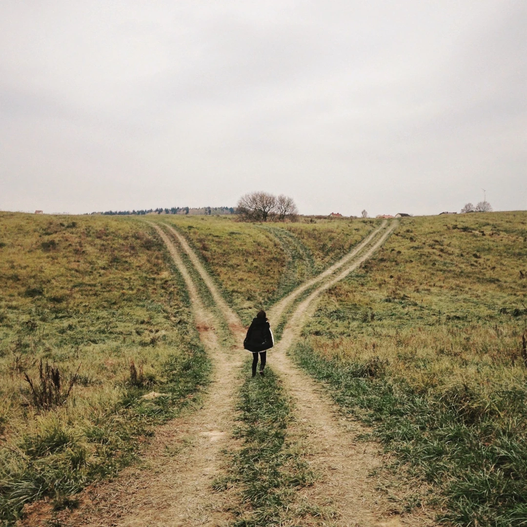 ERP vs I-CBT for OCD Woman standing in front of a path that splits in two, representing the difference between ERP and I-CBT for OCD with Wellness Counseling Pllc